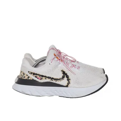 Running shoes (White, Black, Pink) from Nike