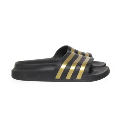 Slip-ins (Black, Gold) from Adidas