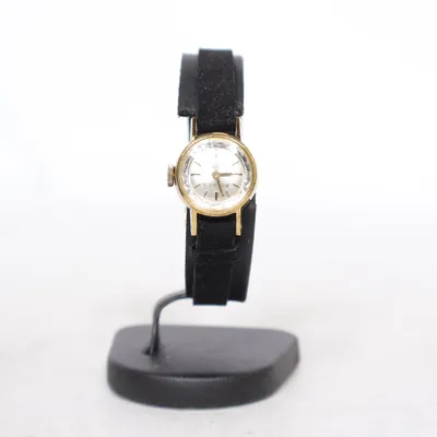 Armbandsur (Small vintage wristwatch with gold-tone case and black strap. Minimal, classic.) från Vintage