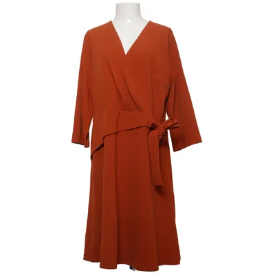 Wikkeljurk (Oranje) van Grace Karin Elastaan, Polyester