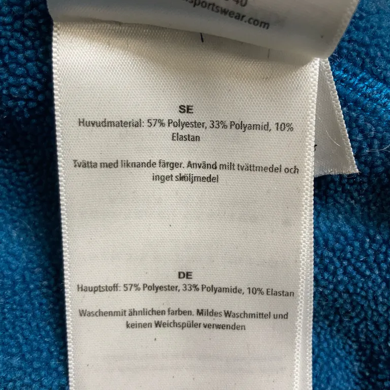 Huvtröja (Blå) från Houdini Polyester, Polyamid, Elastan - Materialetikett