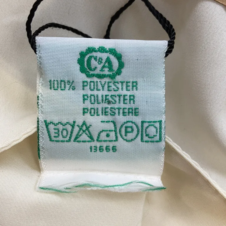 Blus (Benvit) från Canda Polyester - Materialetikett