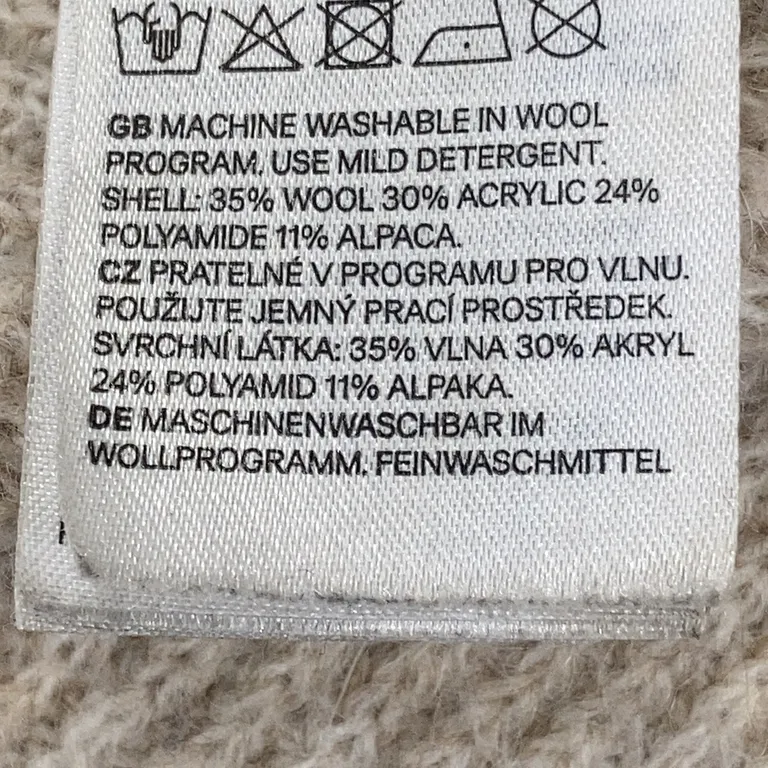 Filt (Beige) från H&M Home Ull, Akryl, Polyamid, Alpackaull - Materialetikett
