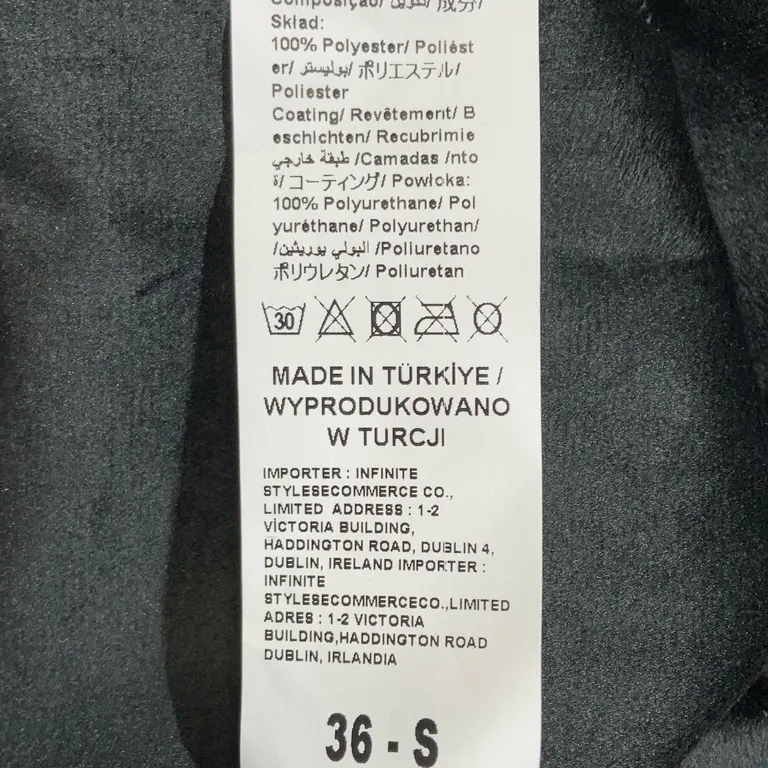 Byxor (Svart) från Aref Polyester, Polyuretan - Materialetikett
