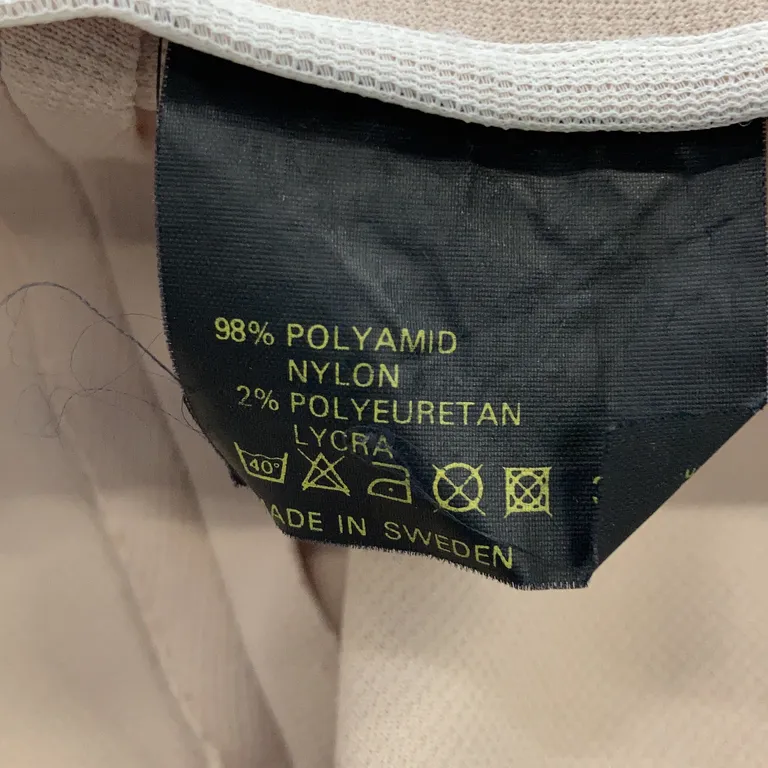 Ridbyxor (Beige) Nylon - Materialetikett